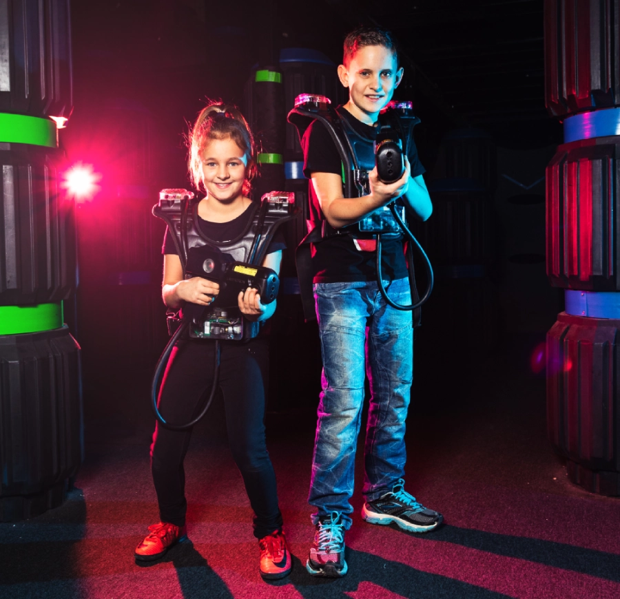 Zwei Kinder mit Phaser und Weste während einem Lasertron Spiel